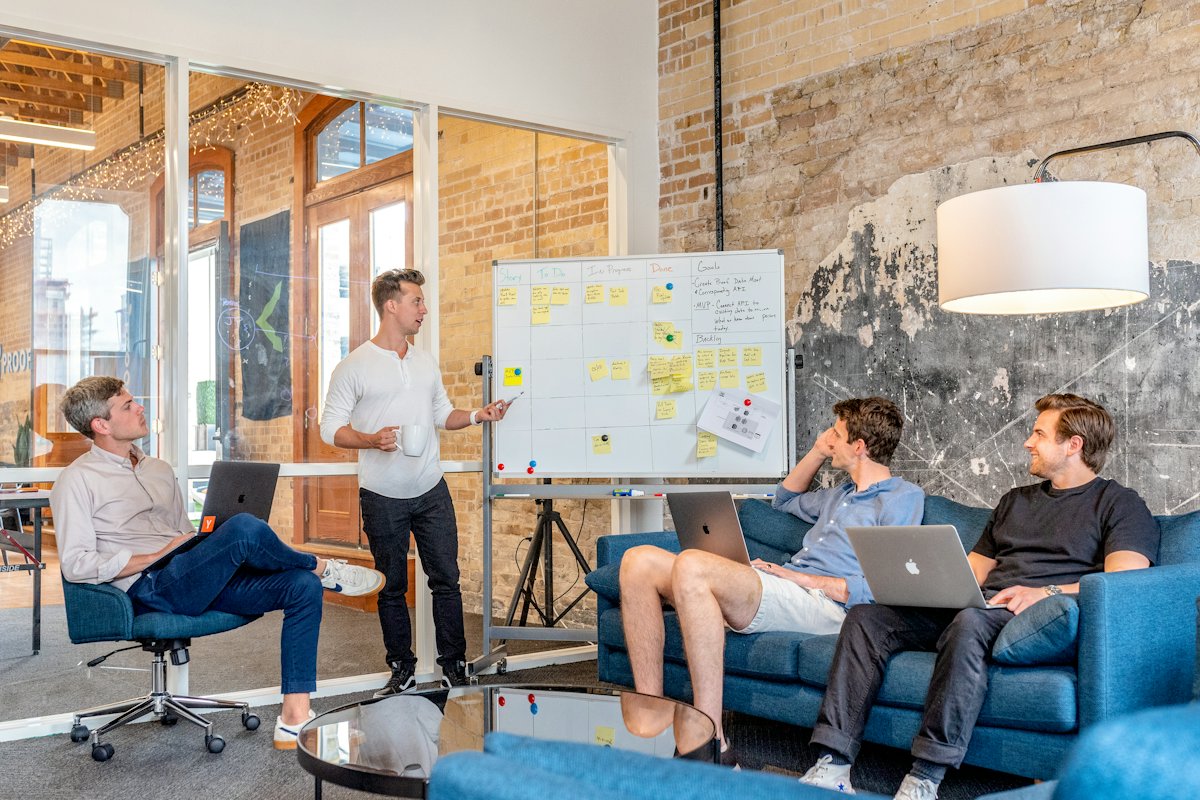 Trainer leading a whiteboard session with a small team
